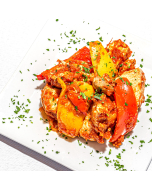 Overhead closeup of chicken scallopini served in a white stoneware bowl