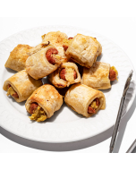 Miniature Coney Island Franks, beef franks wrapped in puff pastry on a wooden board