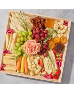 Overhead shot of decoratively arranged cheese tray with white cheese cubes, grapes, and strawberries