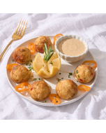 Oblique overhead shot of seasoned Miniature Crabcakes served on a silver platter