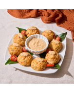 Miniature Roasted Artichoke Patties Close-up side view of artichoke patties on a black wooden platter
