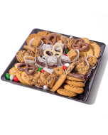 Overhead view of various sweets arranged in a black plastic serving tray. Including chocolate covered pretzels, miniature brownies, chocolate chip cookies, peanut butter cookies, oatmeal cookies, and sugar cookies