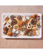 Overhead view of various sweets arranged in a black plastic serving tray.  Including chocolate covered pretzels, miniature brownies, miniature lemon bars, chocolate covered strawberries, and sugar cookies