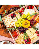 Overhead shot of decoratively arranged cheese tray with white cheese cubes, grapes, and strawberries