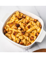 Oblique overhead view of fusilli mac and cheese in a square, white bowl, topped with toasted bread crumbs